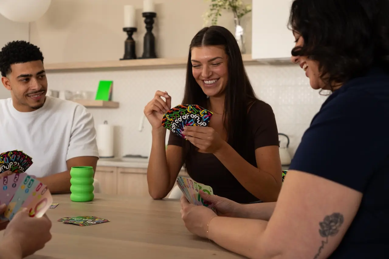 Group of friends laughing during a dnup game night